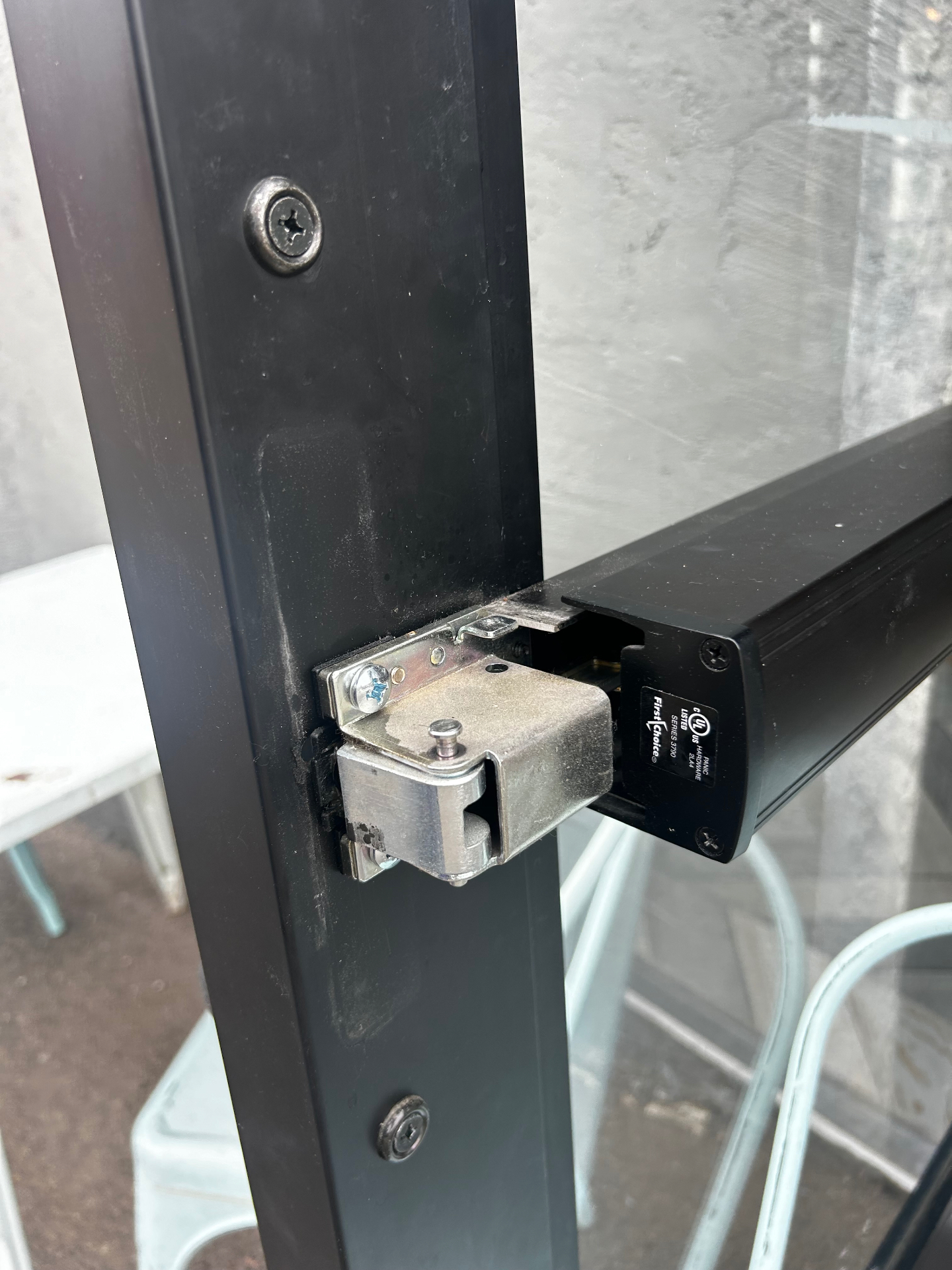 Storefront door latch and exit device hardware aligned during a commercial lock change in Denver, Colorado