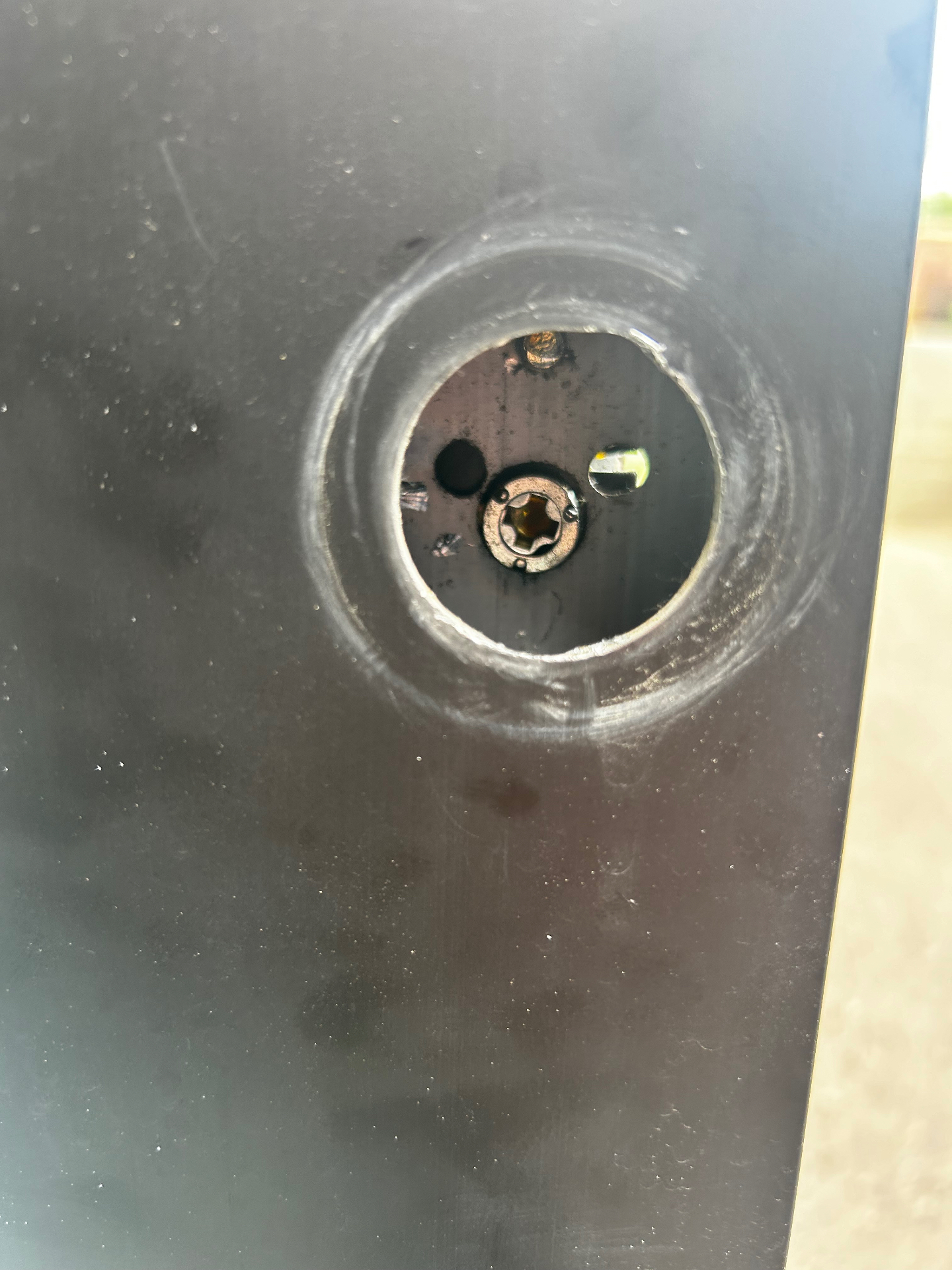 Empty cylinder bore in an aluminum storefront door after removing the old commercial lock in Denver, Colorado