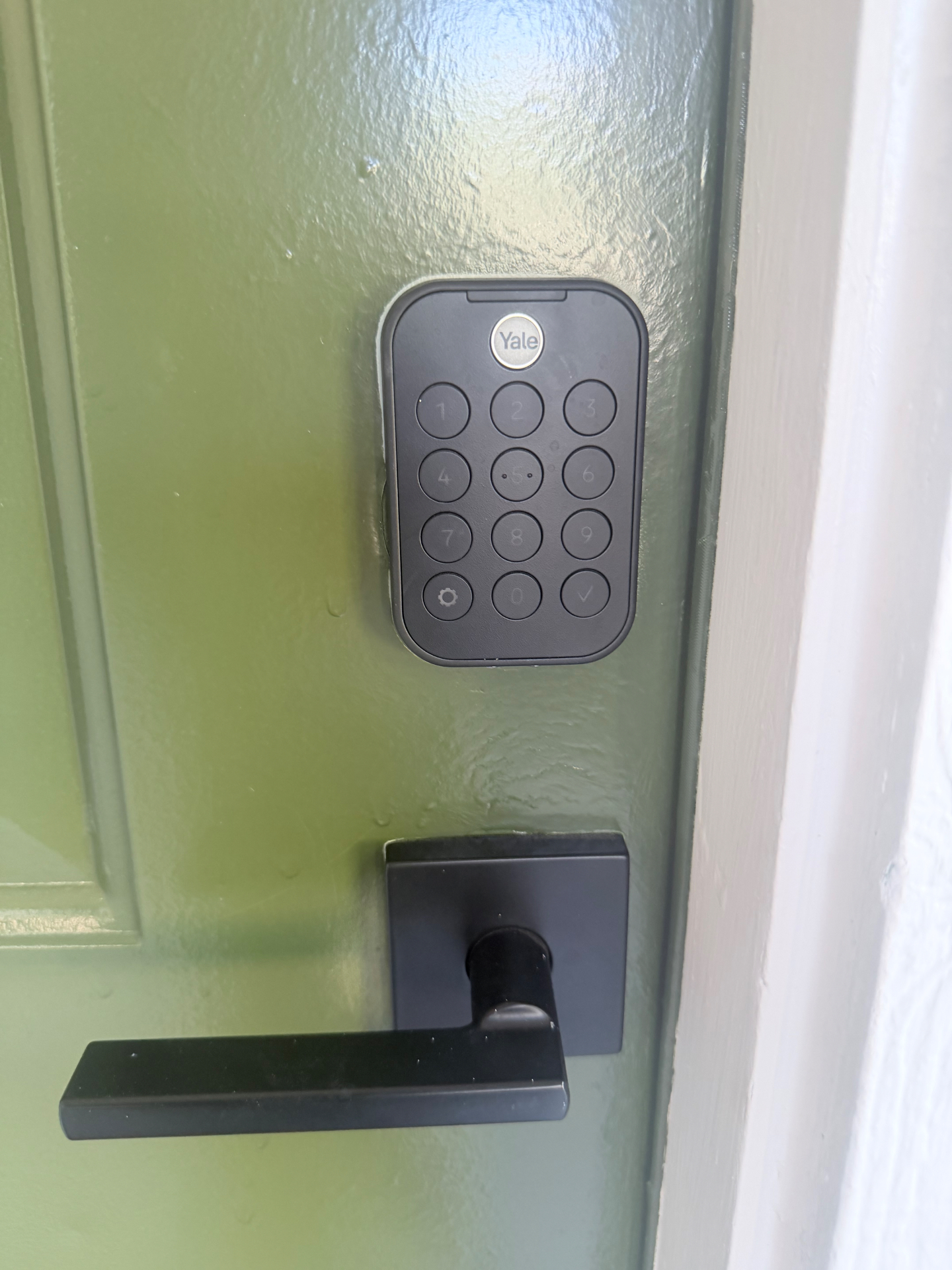 Close-up of black Yale keypad door lock and modern lever handle installed in Lakewood CO