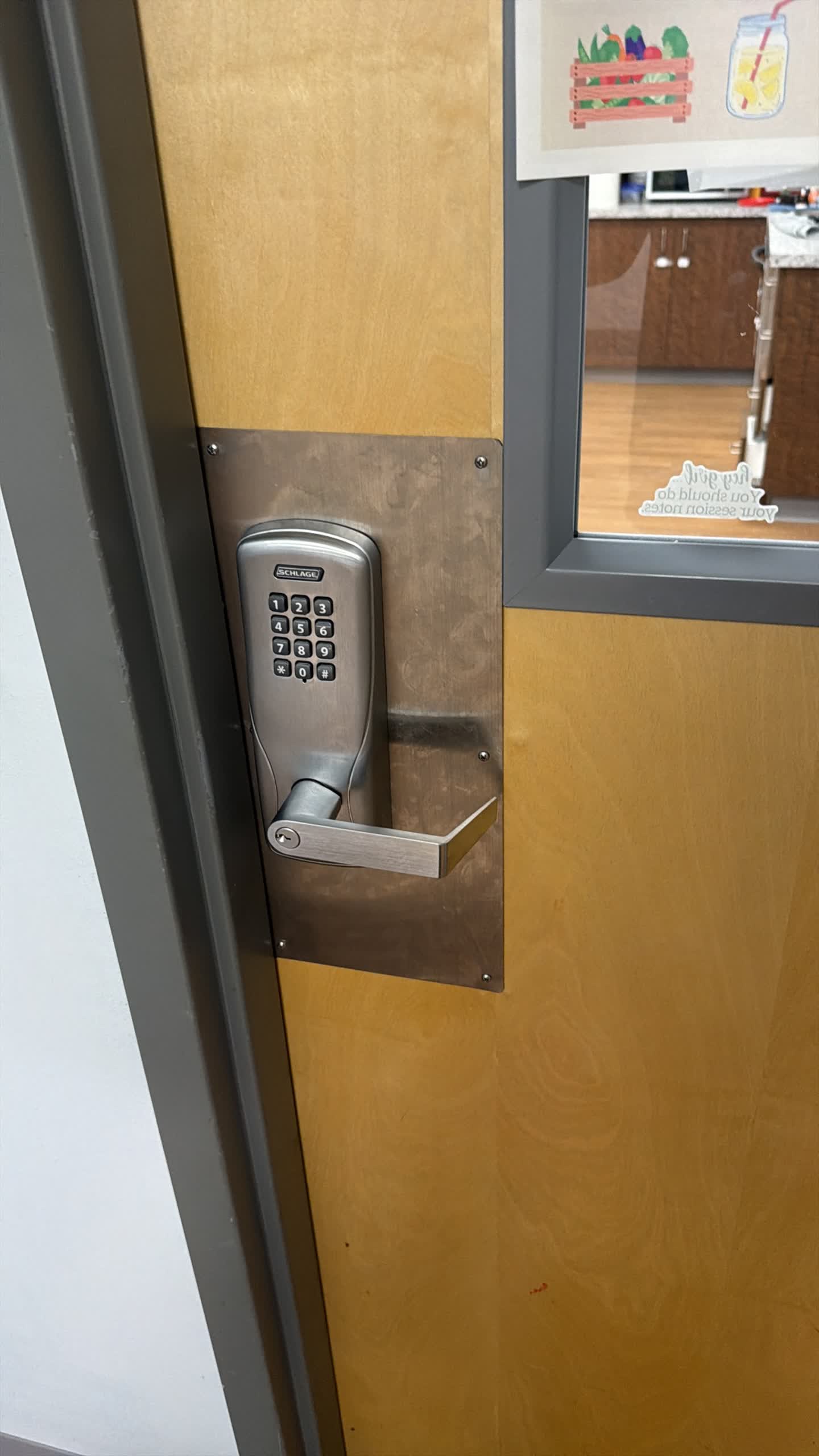 Schlage commercial keypad lever lock installed on a wood office door in Westminster, Colorado