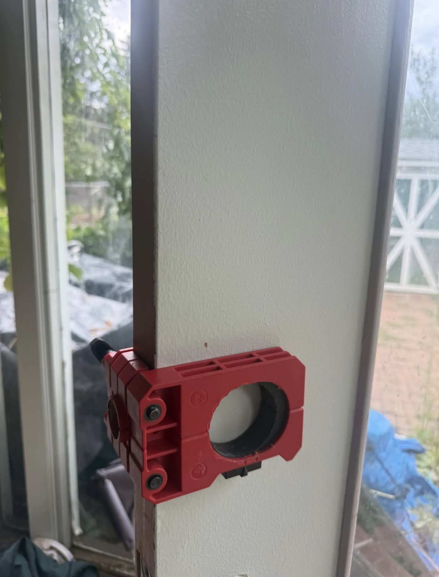 Professional door jig clamped to the door edge to bore a clean deadbolt hole in Lakewood, Colorado