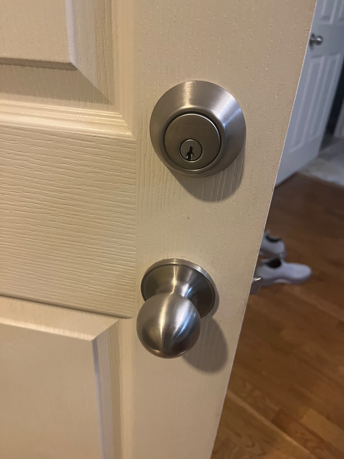 New Schlage satin nickel deadbolt and knob set installed on a residential door in Aurora, Colorado