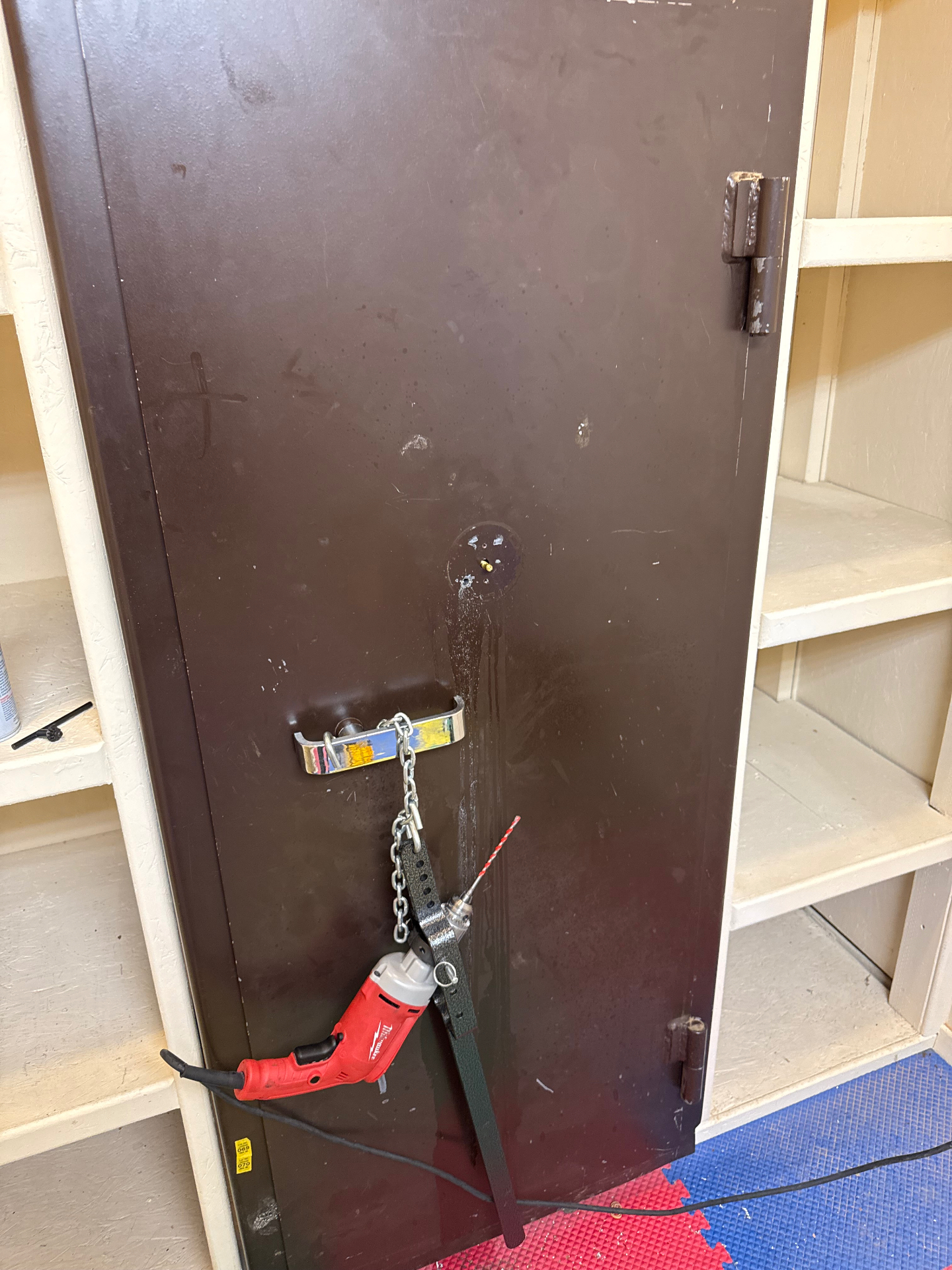 Locksmith drill rig mounted on a safe door during a professional safe opening in Elizabeth, Colorado