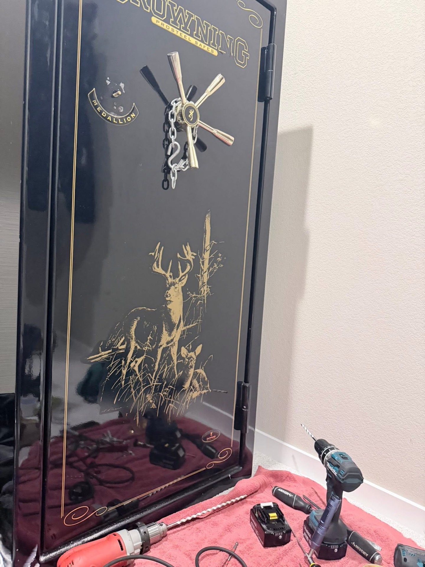 Browning ProSteel gun safe opened during a safe lockout service in Monument, Colorado, with locksmith drilling tools laid out on a protective mat